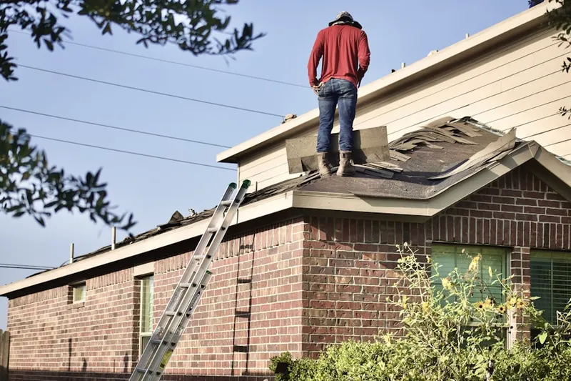 Professional roofer working on a residential roof in Hoover Park